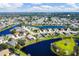 Aerial view of a lakeside neighborhood, highlighting a property circled in orange at 4115 Hemingway Dr, Venice, FL 34293