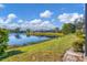 Beautiful lakefront backyard with a well-manicured lawn providing a serene view of the water at 4115 Hemingway Dr, Venice, FL 34293