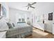 Bright bedroom featuring a ceiling fan, natural light, and neutral decor at 4115 Hemingway Dr, Venice, FL 34293