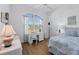 Bright bedroom with a coastal theme, featuring a work space, white wicker furniture, and lots of natural light at 4115 Hemingway Dr, Venice, FL 34293