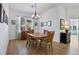 Elegant dining room with a chandelier, hardwood floors, and views into adjacent living spaces at 4115 Hemingway Dr, Venice, FL 34293