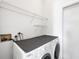 Laundry room with white washer and dryer, wire shelving, and white walls and trim at 4115 Hemingway Dr, Venice, FL 34293