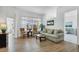 Bright living room with hardwood floors, comfortable seating, and picturesque views of the outdoors at 4115 Hemingway Dr, Venice, FL 34293