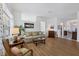 Inviting living room featuring hardwood floors, neutral decor, and large windows for abundant natural light at 4115 Hemingway Dr, Venice, FL 34293