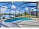 A screened-in pool is surrounded by a view of a tranquil lake and well-maintained landscaping at 4115 Hemingway Dr, Venice, FL 34293
