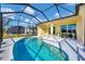 A screened-in pool is connected to the home with seating, dining, and lounge area and outdoor space at 4115 Hemingway Dr, Venice, FL 34293
