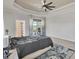 Relaxing main bedroom featuring plush carpet, neutral tones, and a large window offering views of the outdoors at 448 Rotonda Cir, Rotonda West, FL 33947