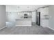 Modern kitchen with granite countertops, stainless steel appliances, white cabinets, and pendant lighting over the island at 5273 Gillot Blvd, Port Charlotte, FL 33981