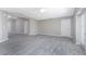 Spacious living room with gray wood-look floors, a tray ceiling, and neutral walls at 5273 Gillot Blvd, Port Charlotte, FL 33981