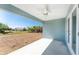 Covered outdoor patio with ceiling fan overlooks a spacious, well-lit backyard at 5273 Gillot Blvd, Port Charlotte, FL 33981