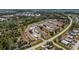 Extensive aerial view of a vibrant 55+ community surrounded by scenic lakes and lush greenery at 6796 Gasparilla Pines Blvd # 63, Englewood, FL 34224