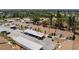 Aerial view of the property in a serene community, showcasing roof, landscaping, and carport at 6796 Gasparilla Pines Blvd # 63, Englewood, FL 34224