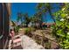 Tiled patio in backyard with lush greenery and mature trees provides serene outdoor living space at 6796 Gasparilla Pines Blvd # 63, Englewood, FL 34224