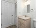 Functional bathroom featuring a neutral-toned vanity, a mirror, and a sliding door for privacy at 6796 Gasparilla Pines Blvd # 63, Englewood, FL 34224