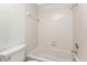 Bathroom showcasing a neutral-toned tub and shower combination, and a toilet at 6796 Gasparilla Pines Blvd # 63, Englewood, FL 34224