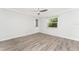Spacious bedroom with wood-look flooring, neutral paint, and natural light at 6796 Gasparilla Pines Blvd # 63, Englewood, FL 34224