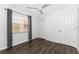 Cozy bedroom featuring wood floors, a window for natural light, and a convenient closet at 6796 Gasparilla Pines Blvd # 63, Englewood, FL 34224