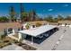 Charming condo with assigned covered parking, mature landscaping, and neutral exterior paint at 6796 Gasparilla Pines Blvd # 63, Englewood, FL 34224