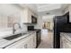 Updated kitchen featuring black appliances, granite countertops, and stainless steel sink at 6796 Gasparilla Pines Blvd # 63, Englewood, FL 34224