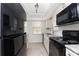 Updated kitchen with granite countertops, stainless steel sink, and white cabinetry at 6796 Gasparilla Pines Blvd # 63, Englewood, FL 34224