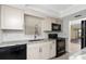 Well-lit kitchen featuring stainless steel sink, granite countertops, and black appliances at 6796 Gasparilla Pines Blvd # 63, Englewood, FL 34224