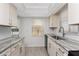 Updated kitchen featuring new stainless steel sink, granite countertops, and shaker cabinets at 6796 Gasparilla Pines Blvd # 63, Englewood, FL 34224