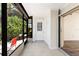 Enclosed lanai with tile flooring, access to outdoor greenery, and sliding door to the main living area at 6796 Gasparilla Pines Blvd # 63, Englewood, FL 34224
