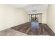 Open living room with sliding doors to a screened in patio, vaulted ceilings and ceiling fan at 6796 Gasparilla Pines Blvd # 63, Englewood, FL 34224