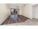Bright living room with laminate flooring and sliding glass doors to the lanai at 6796 Gasparilla Pines Blvd # 63, Englewood, FL 34224