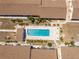 Aerial view of community pool with lounge chairs and lush landscaping at 6796 Gasparilla Pines Blvd # 63, Englewood, FL 34224