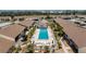 Community pool area with pristine pool, ample seating, lush landscaping and beautiful pavers at 6796 Gasparilla Pines Blvd # 63, Englewood, FL 34224