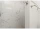 Beautiful shower with marble-look tiles, modern fixtures, and convenient towel bars for a luxurious feel at 6796 Gasparilla Pines Blvd # 63, Englewood, FL 34224