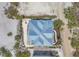 Aerial view of home showcasing architectural roof design, lush landscaping, and beach access at 6890 Palm Island Dr, Placida, FL 33946