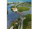 Aerial view of the ferry terminal, highlighting transportation convenience amidst a lush coastal landscape at 6890 Palm Island Dr, Placida, FL 33946
