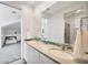 Bathroom with double sinks, white cabinetry, and shower in the background at 6890 Palm Island Dr, Placida, FL 33946