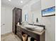 Well-lit bathroom with modern vanity, dark wood cabinet, and television at 6890 Palm Island Dr, Placida, FL 33946