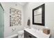Contemporary bathroom with a large mirror, updated fixtures, and seashell decoration at 6890 Palm Island Dr, Placida, FL 33946