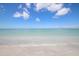 Beautiful beach with gentle waves meeting the sandy shore, creating a relaxing view at 6890 Palm Island Dr, Placida, FL 33946