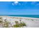 Expansive ocean view with white sand beach, clear blue water, and lush tropical greenery at 6890 Palm Island Dr, Placida, FL 33946