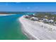 Scenic coastal view of waterfront homes, white sandy beaches, and sparkling turquoise waters at 6890 Palm Island Dr, Placida, FL 33946