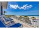 Spacious deck with lounge chairs overlooking a pristine beach and ocean at 6890 Palm Island Dr, Placida, FL 33946