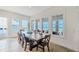 Light and bright dining area featuring a rustic wooden table and views of the beach at 6890 Palm Island Dr, Placida, FL 33946