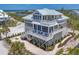 Beautiful stilted home with multiple decks and outdoor seating offering panoramic views of the surrounding landscape at 6890 Palm Island Dr, Placida, FL 33946