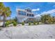 Beautiful coastal home elevated on stilts offering scenic beach views and multiple windows at 6890 Palm Island Dr, Placida, FL 33946