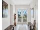 Inviting hallway featuring tile floors, benches, and doors leading to outdoor views at 6890 Palm Island Dr, Placida, FL 33946