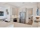 Modern kitchen featuring stainless steel appliances and sleek countertops, with laundry room access at 6890 Palm Island Dr, Placida, FL 33946