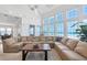 Inviting living room with ocean views, comfortable sectional, and stylish decor at 6890 Palm Island Dr, Placida, FL 33946