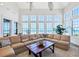 Spacious living room featuring large windows with beach views and comfortable sectional sofa at 6890 Palm Island Dr, Placida, FL 33946