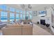 Bright and airy living room with large windows offering stunning beach views and comfortable seating at 6890 Palm Island Dr, Placida, FL 33946