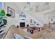 Open-concept living room showcasing a fireplace, staircase, and cozy seating arrangement at 6890 Palm Island Dr, Placida, FL 33946